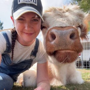 April Crossley of Homes of Grace with Highland Cow